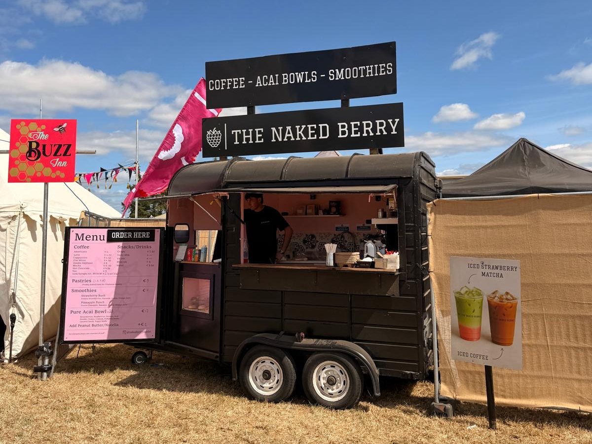 The black Naked Berry Horsebox with its pink menu board under a blue sky