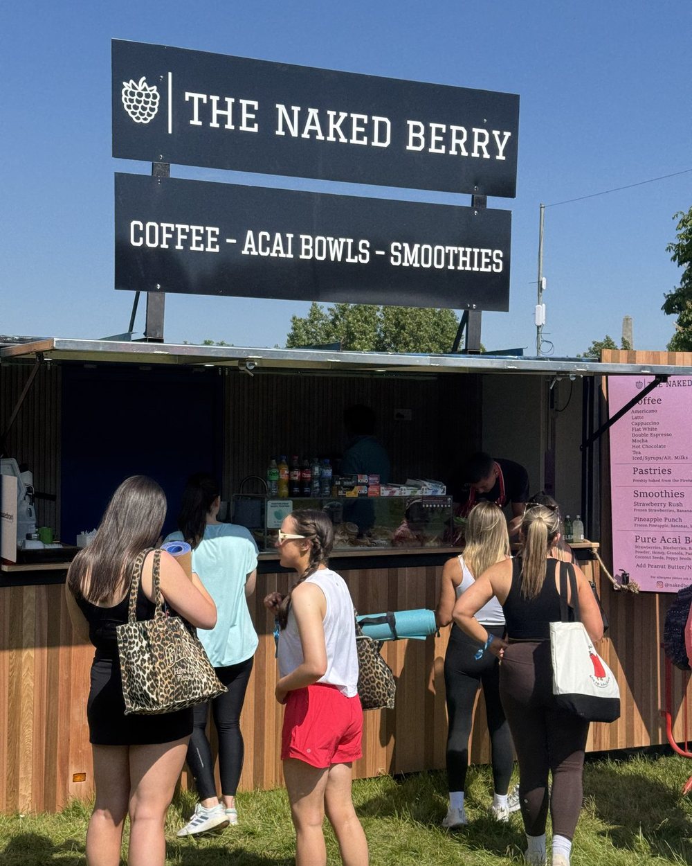 A queue at The Naked Berry trailer at a sunny festival